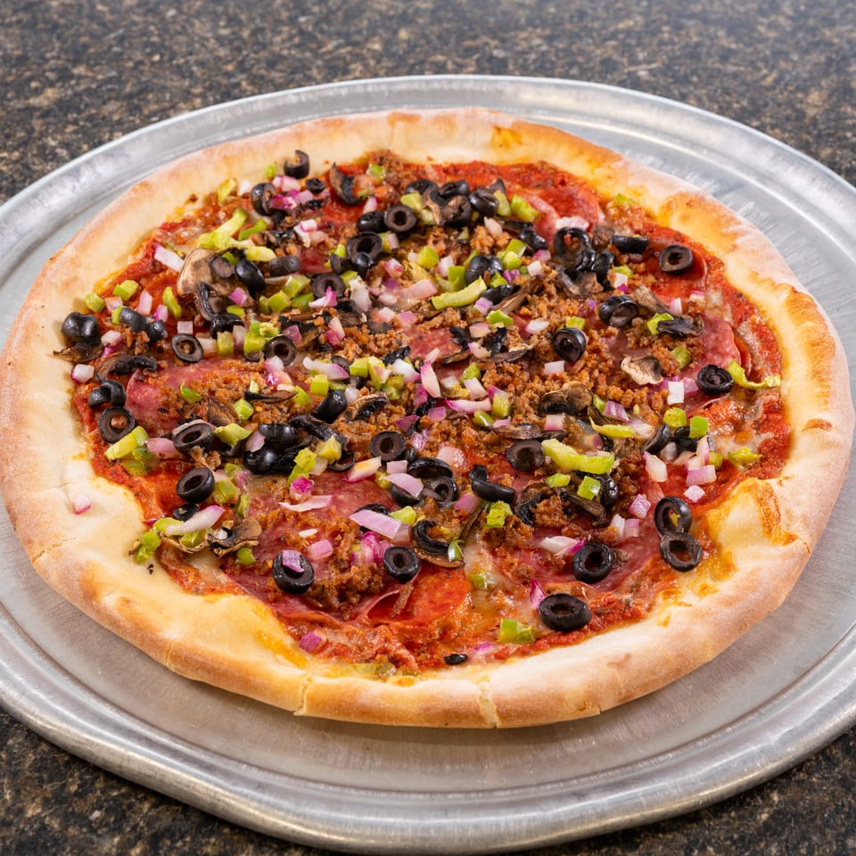 A whole pizza with pepperoni, sausage, mushrooms, black olives, green peppers, and red onions.