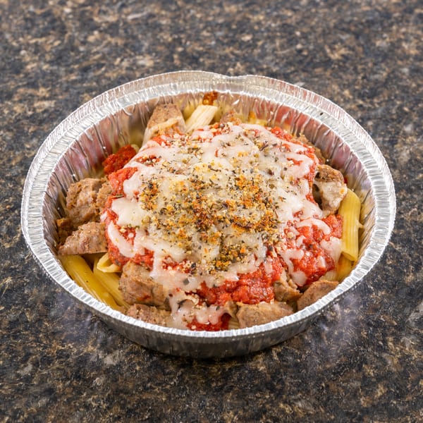 Baked ziti with sausage, marinara, and melted cheese in a foil takeout container.